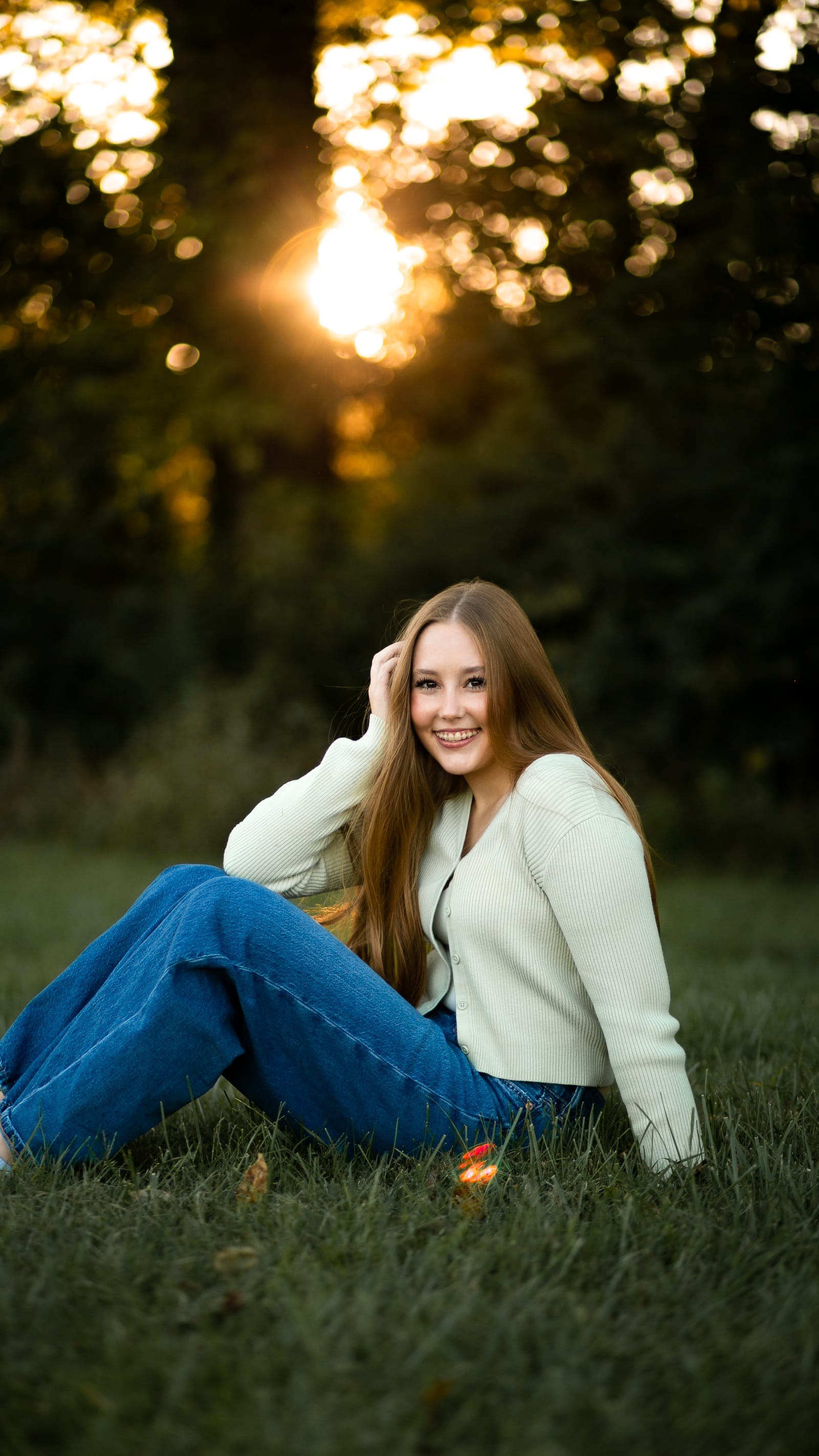 Portrait sitting in grass at sunset
