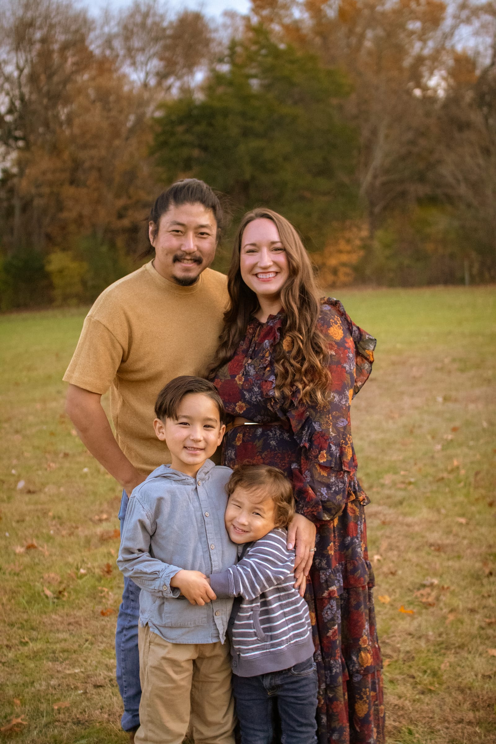 Family of four portrait in autumn field