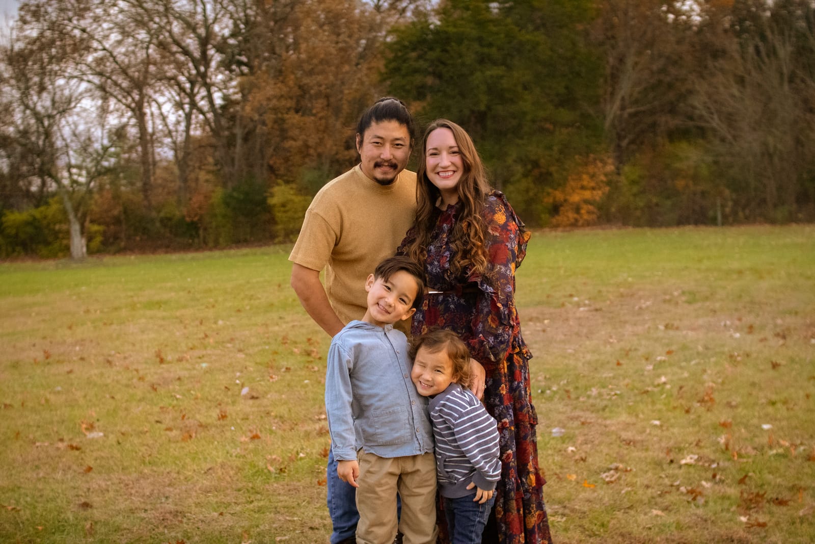 Family of four standing together outdoors