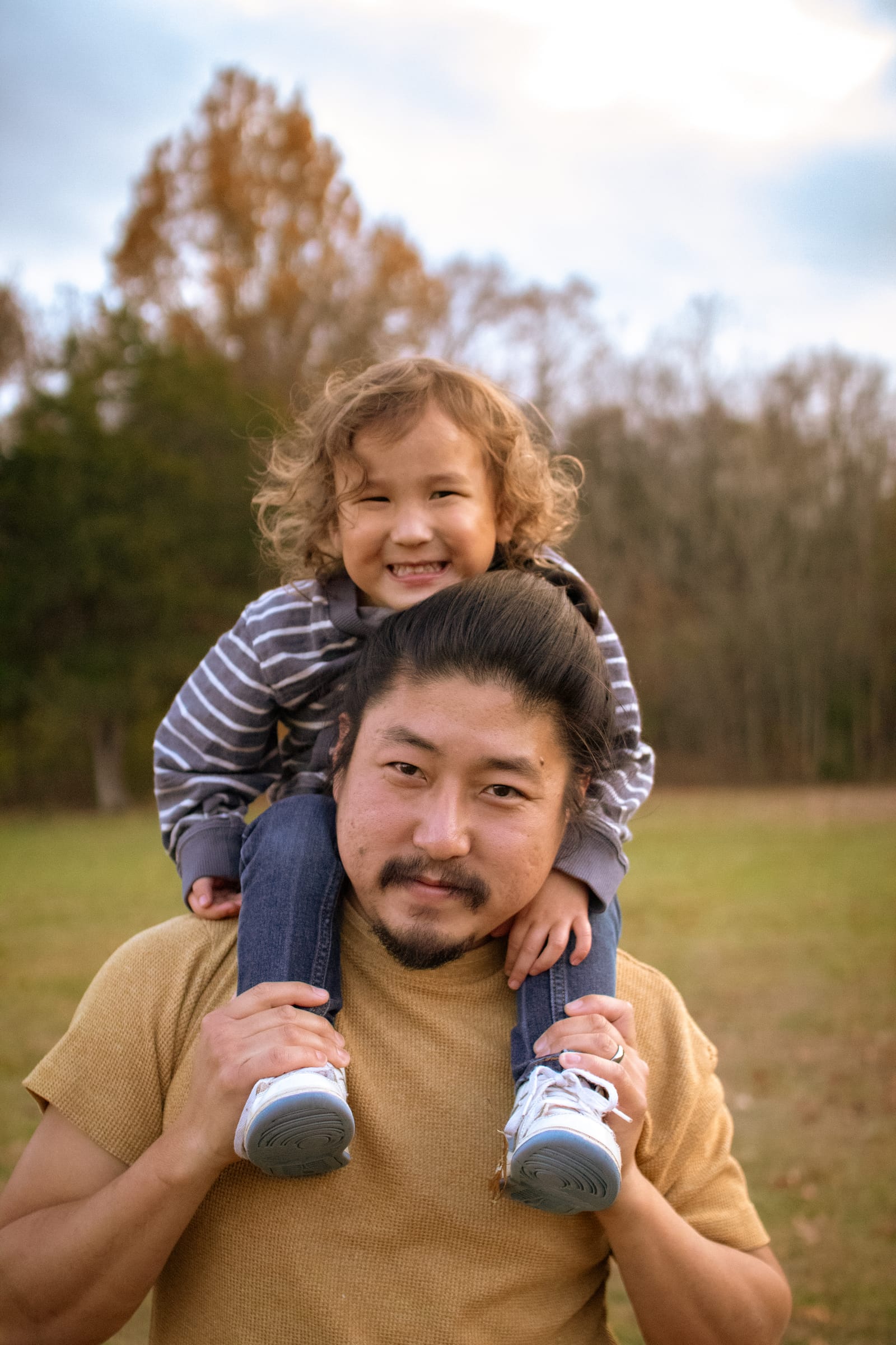 Dad carrying child on shoulders