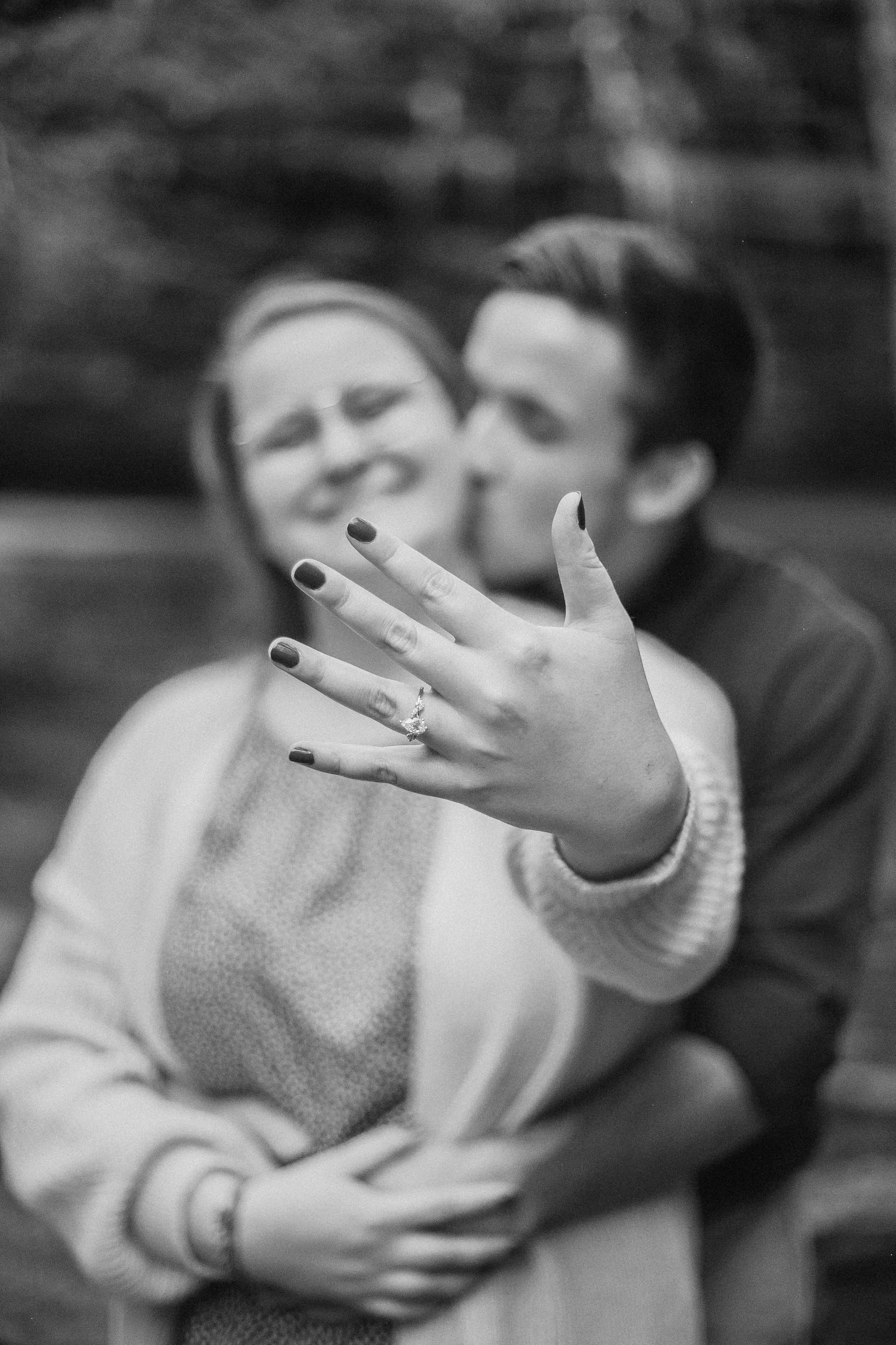 Couple showing off engagement ring