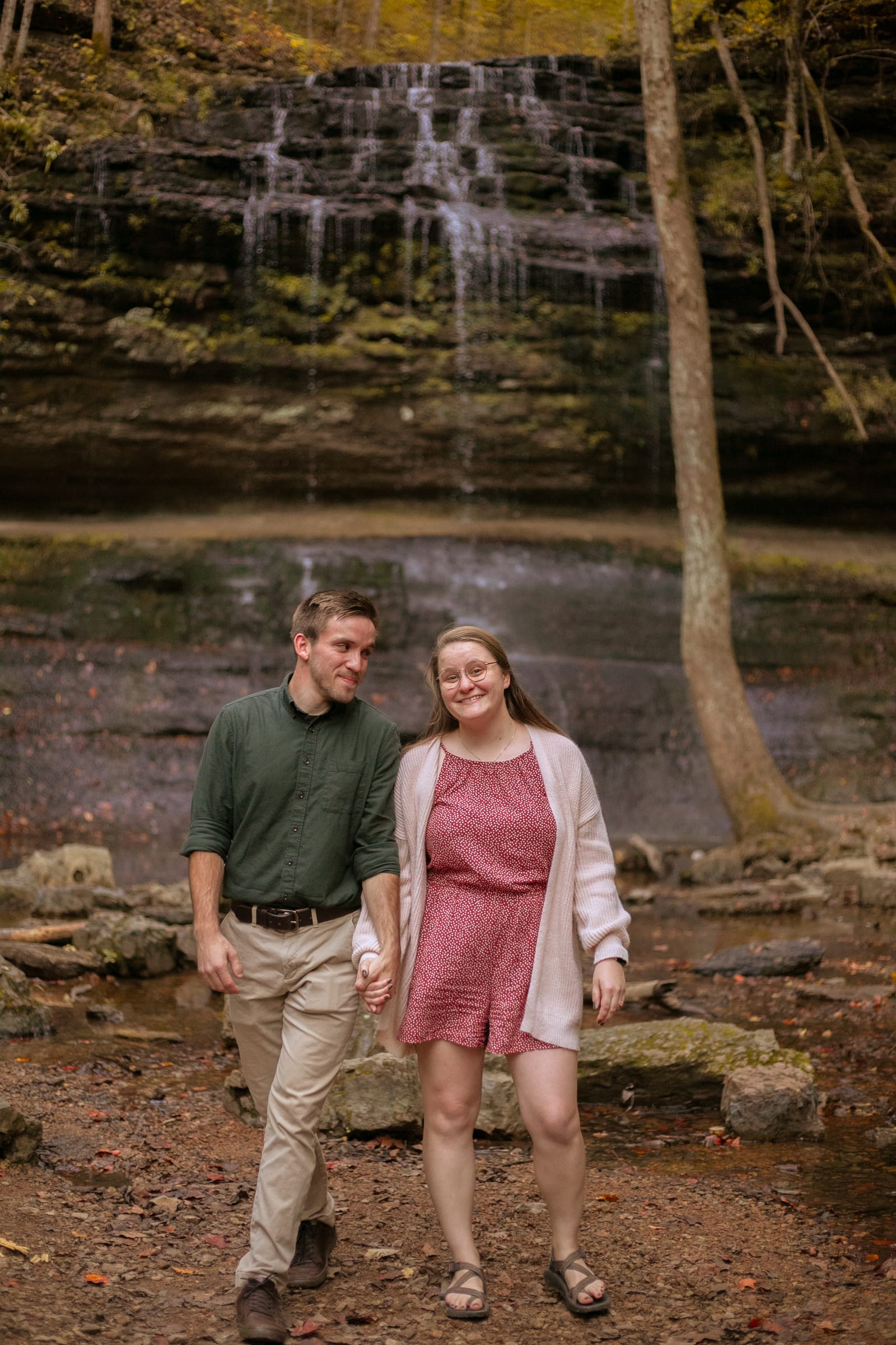 Couple walking by waterfall