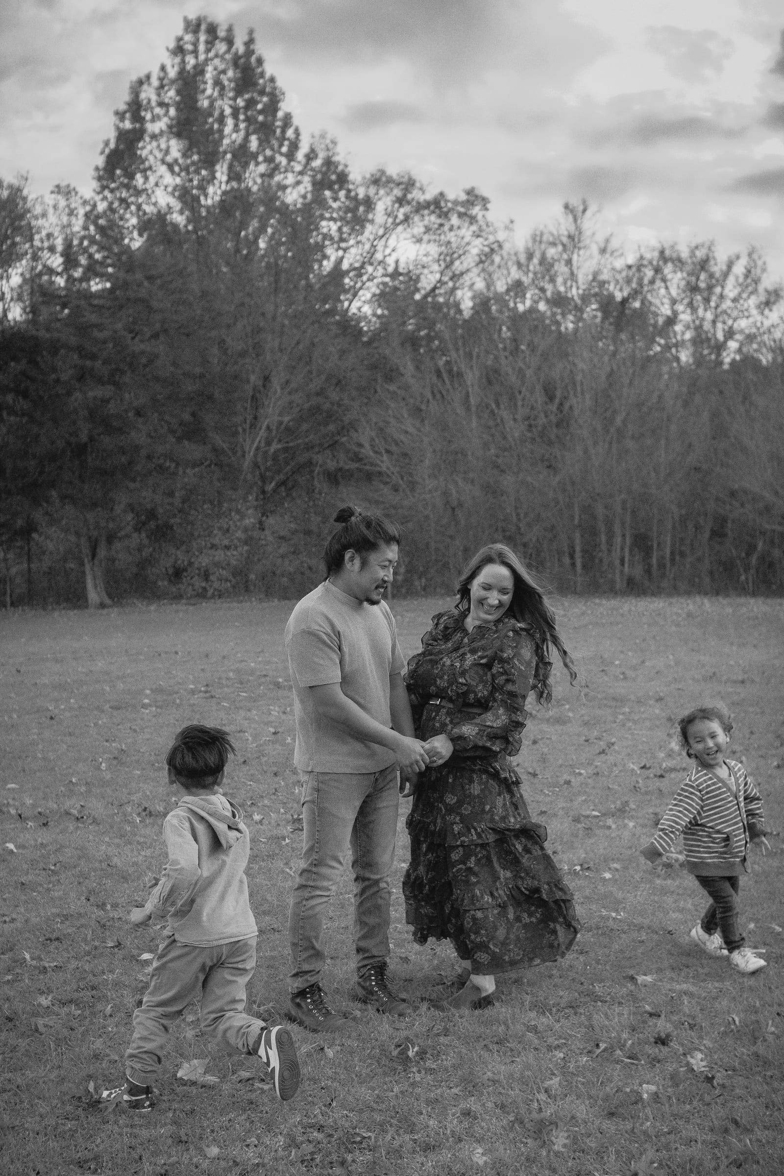 Family of four playing in a field