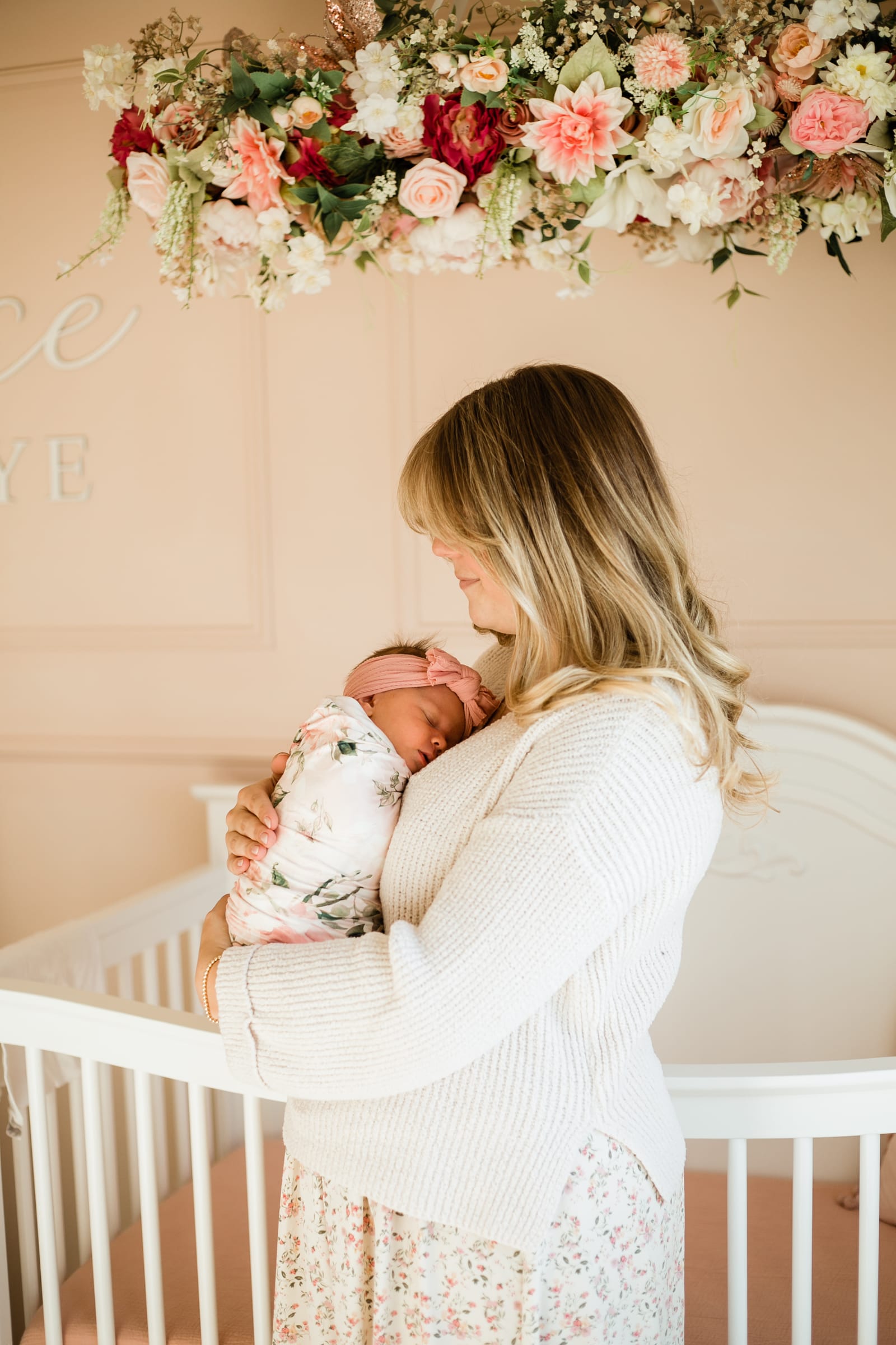 Mother holding newborn in nursery