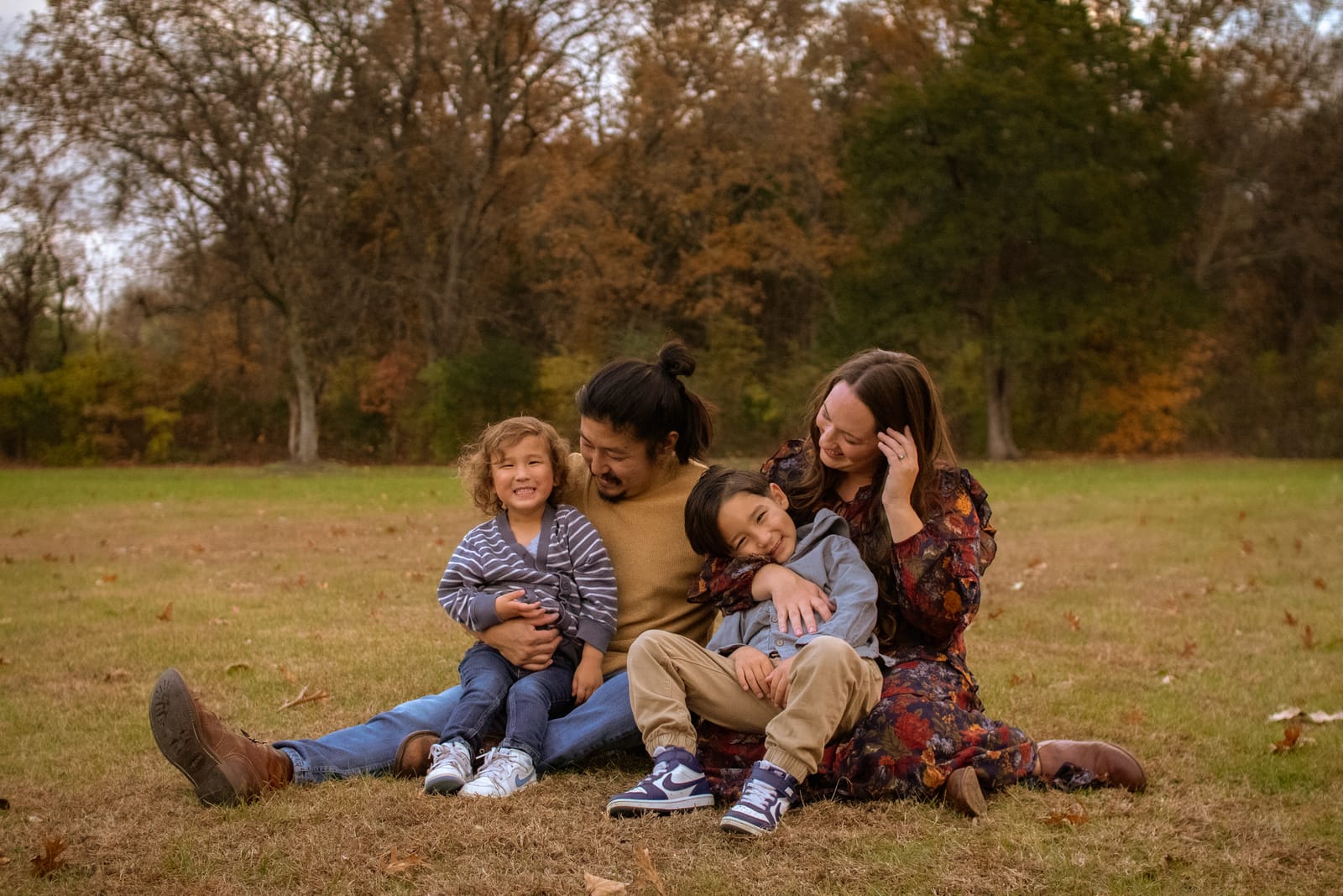 Family sitting together in autumn field